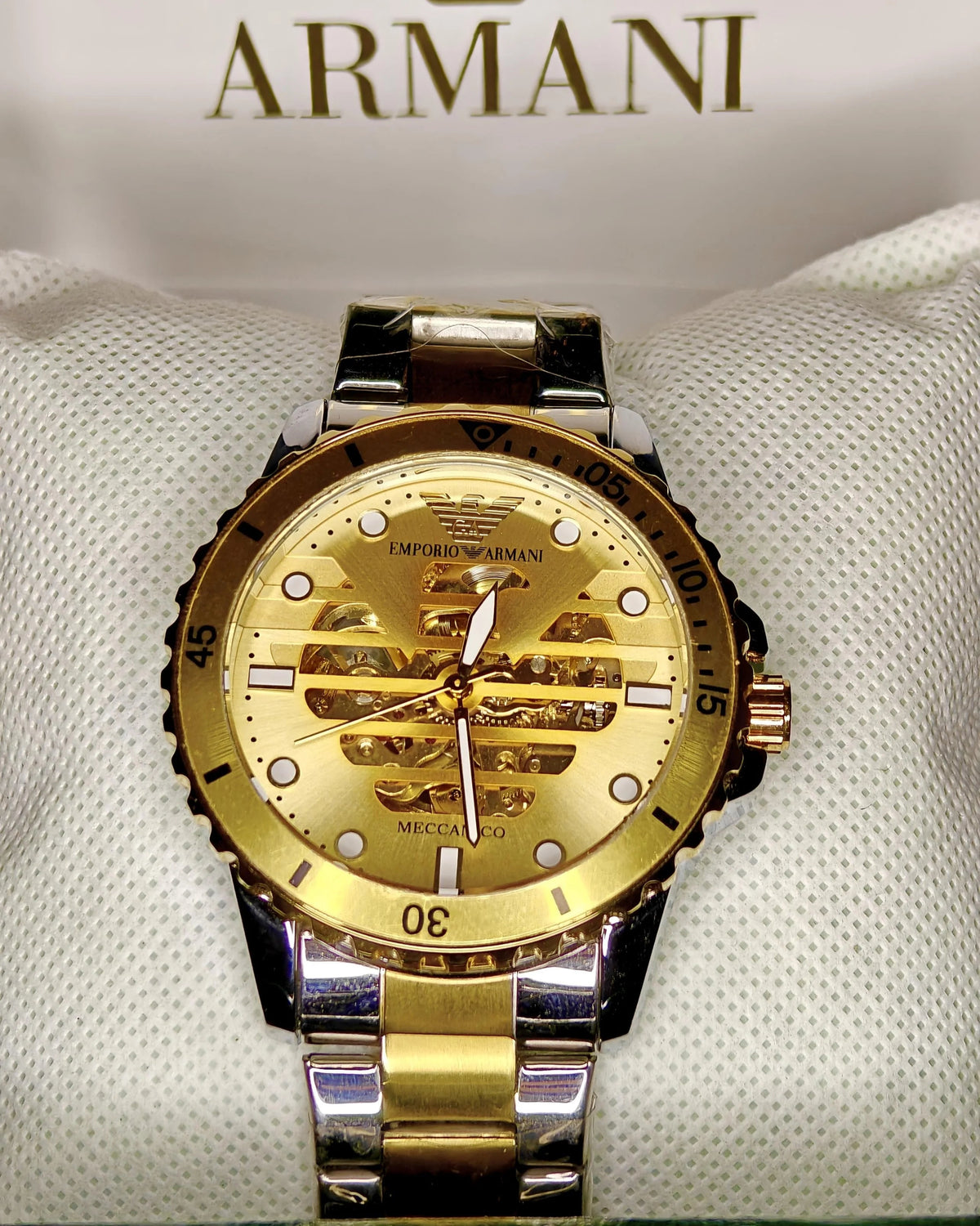 Gold and silver Emporio Armani watch on a white background