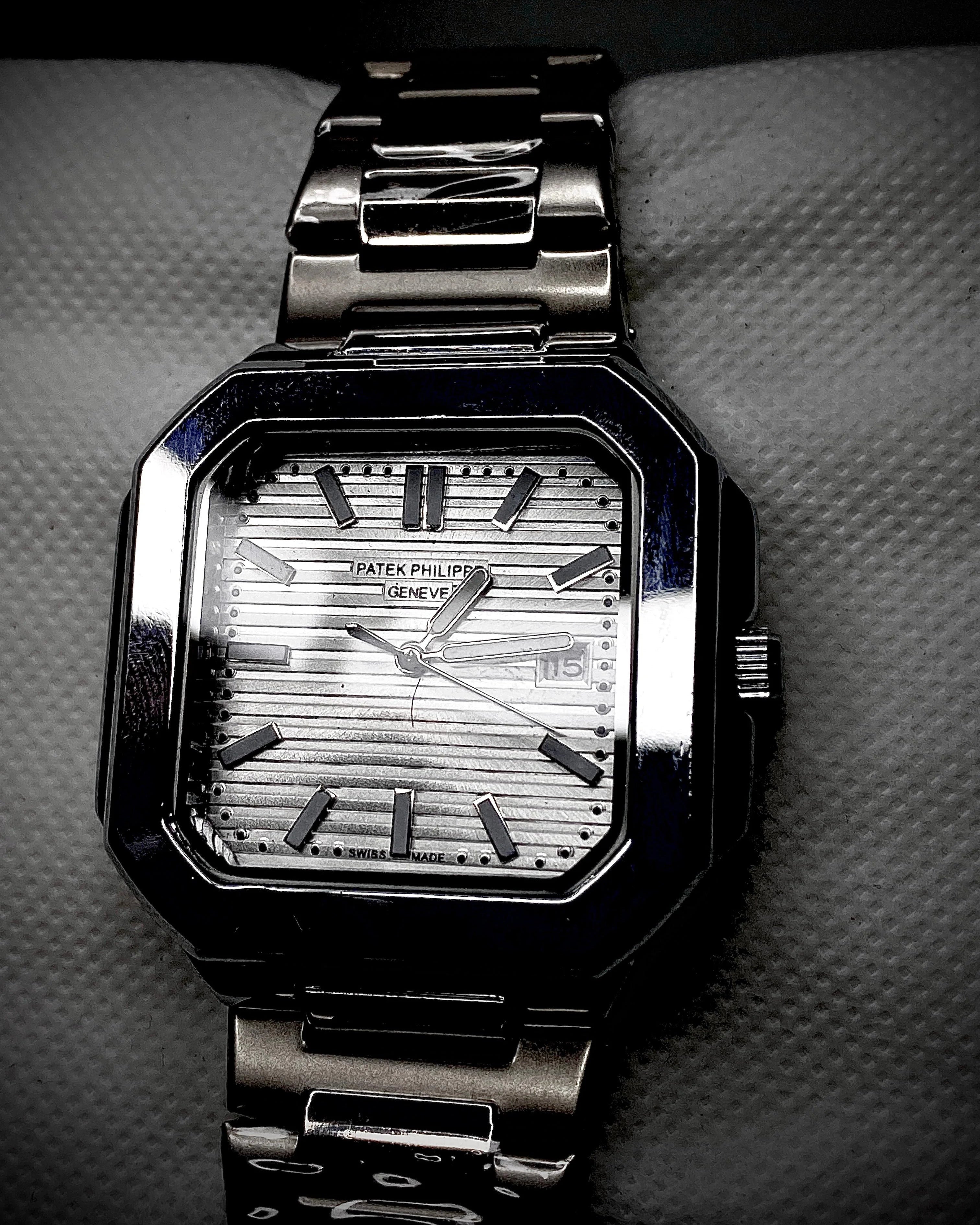 Silver wristwatch with a detailed face on a textured surface