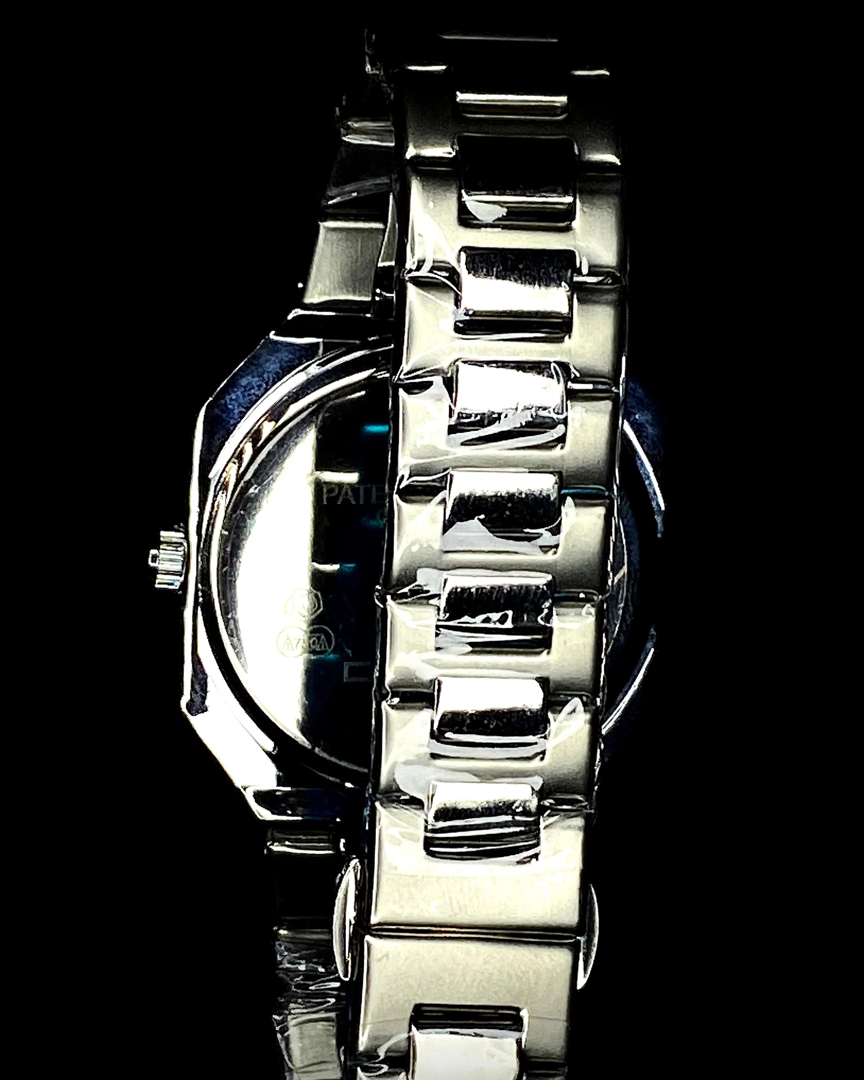 Silver watch with a metallic band on a black background